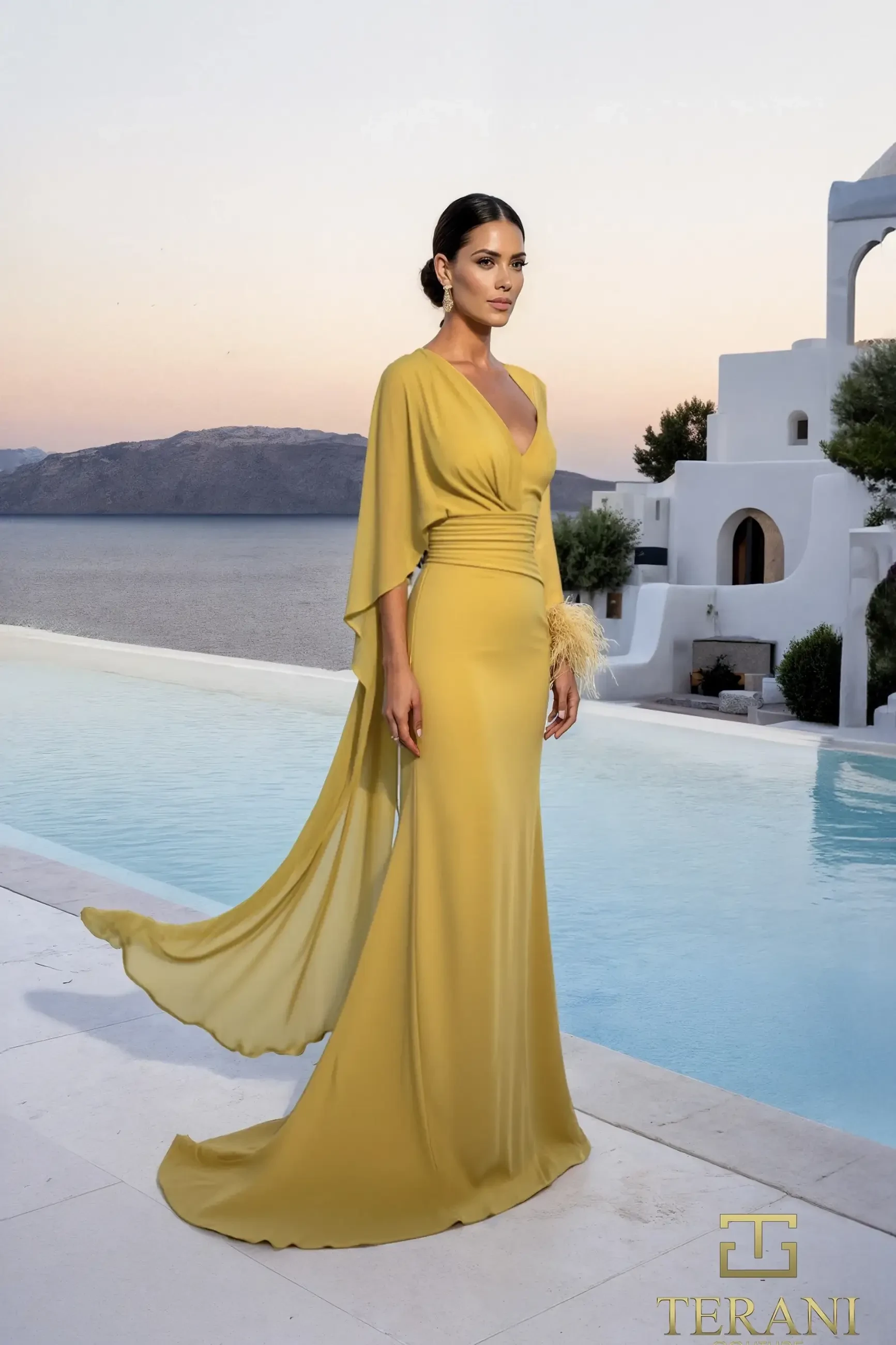 A woman in an elegant, flowing mustard gown poses gracefully by an infinity pool at sunset. The backdrop features white architecture and distant hills.