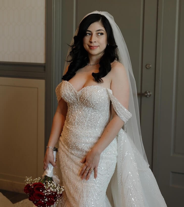 Model wearing a bridal gown with flowers